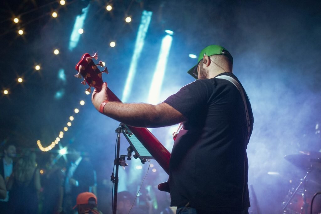 Guitarist playing to a crowd on stage
